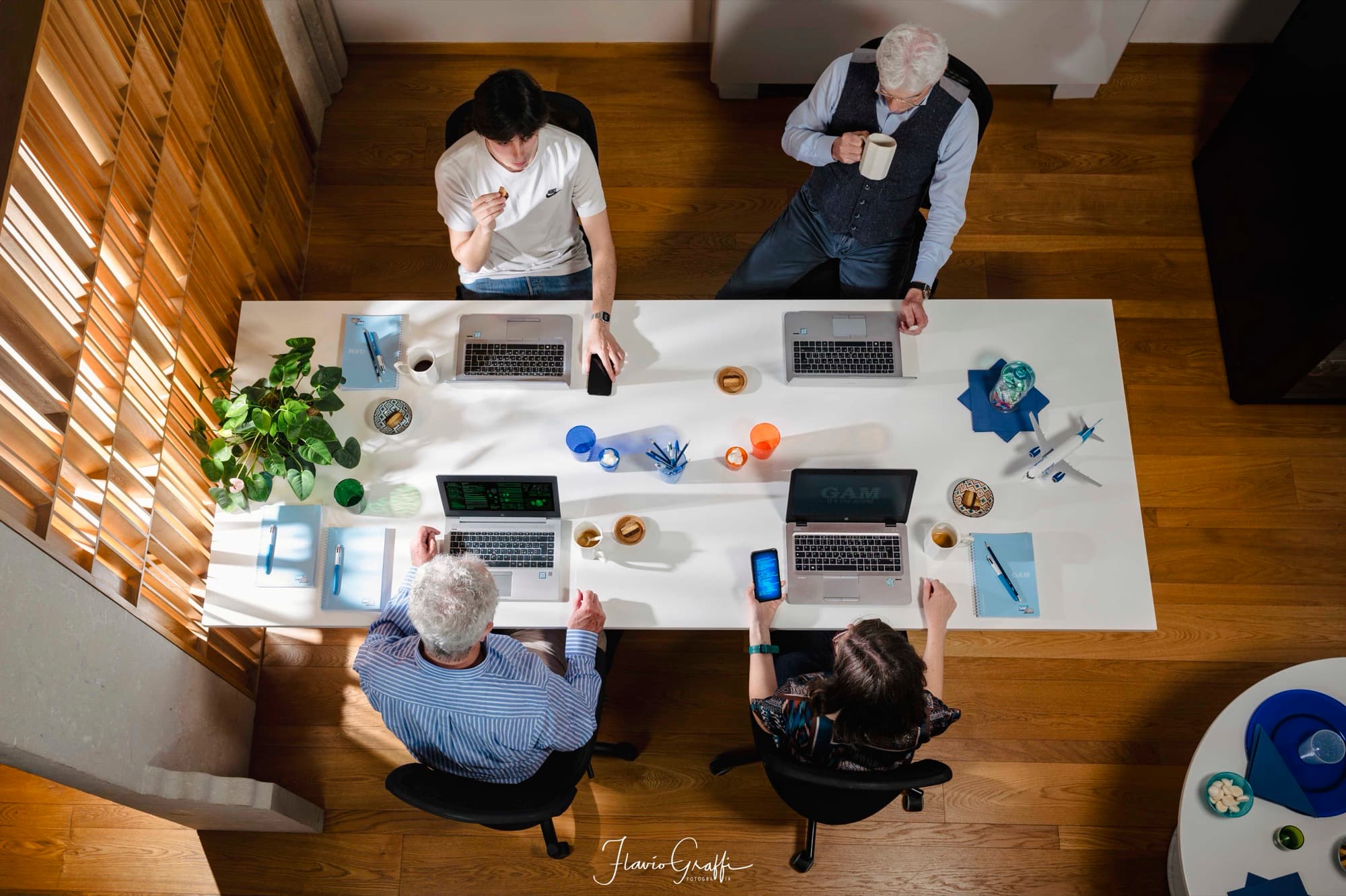 The GAM team working around a large table, seen from above